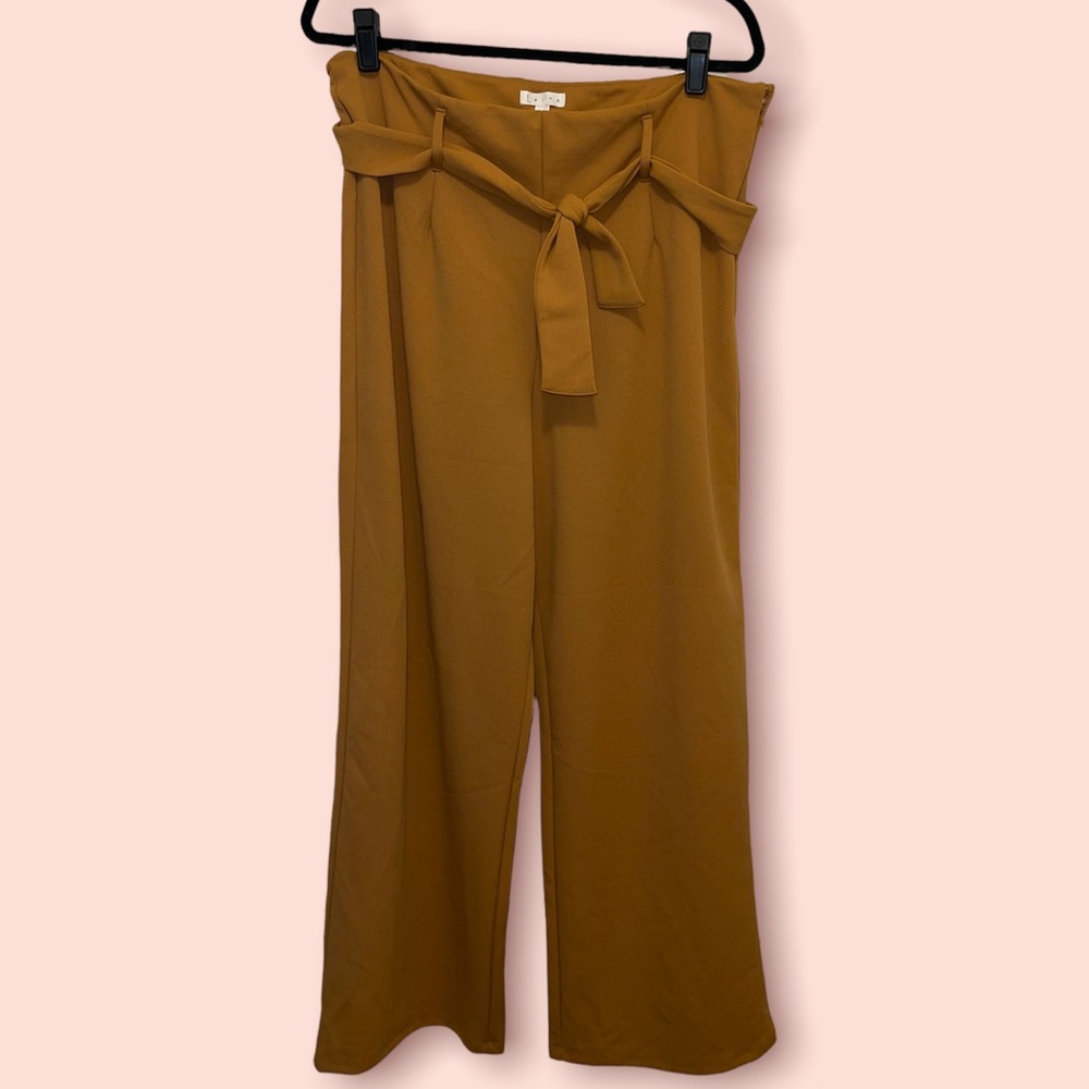 Mustard colored tie waist pants. Wide leg at bottom.